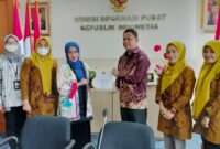 Penerimaan sertifikat cukup informatif yang diberikan Komisi Informasi Indonesia Rospita Vici Paulyn kepada Kabid Guntur Sudirman.