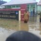 Camat Oba Selatan, Udin Hasan di depan SD Negeri 2 Maidi tergenang air. 